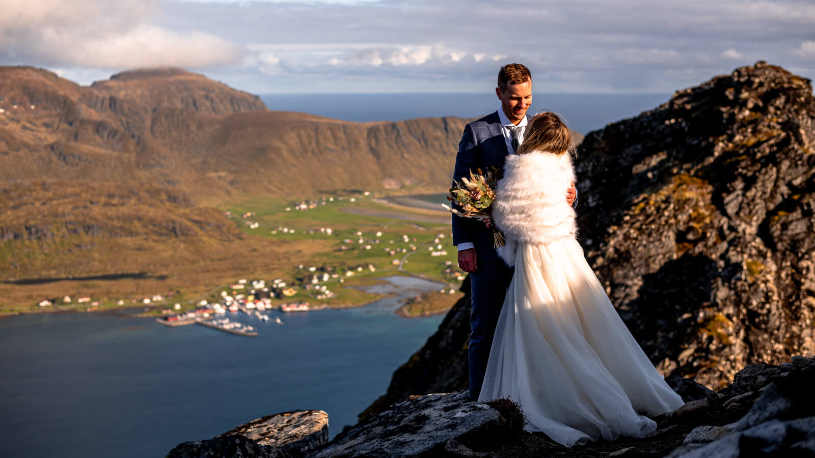 Wedding couple on a mountain top at Lofoten islands