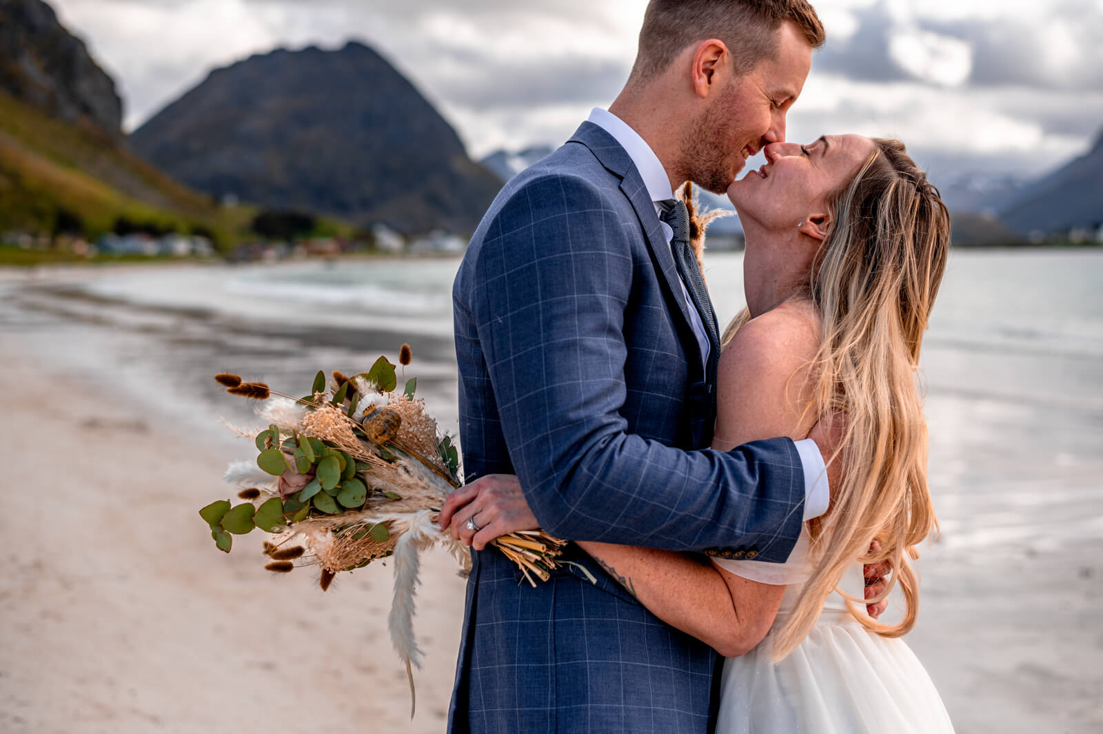 Detail of a wedding couple kissing on a beach at Lofoten islands