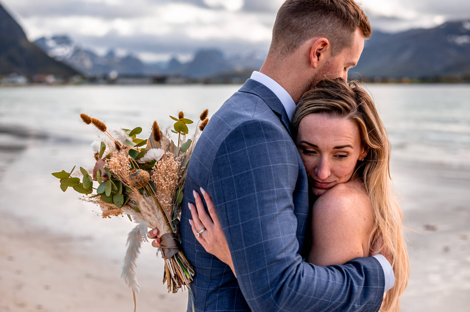 Detail of a wedding couple hugging on a beach at Lofoten islands