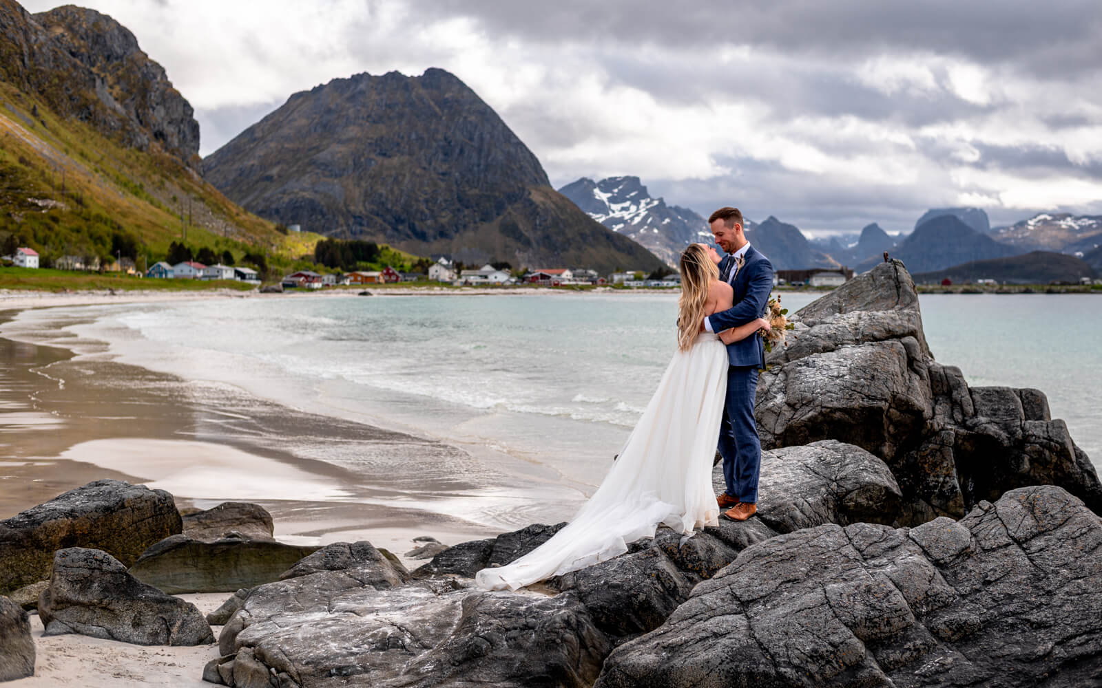 Elopement couple hugging on a rock at a beach at Lofoten islands
