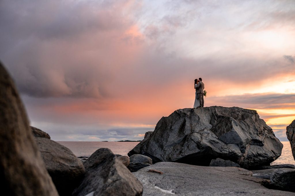 A couple kissing at Lofoten islands during dramatic sunset