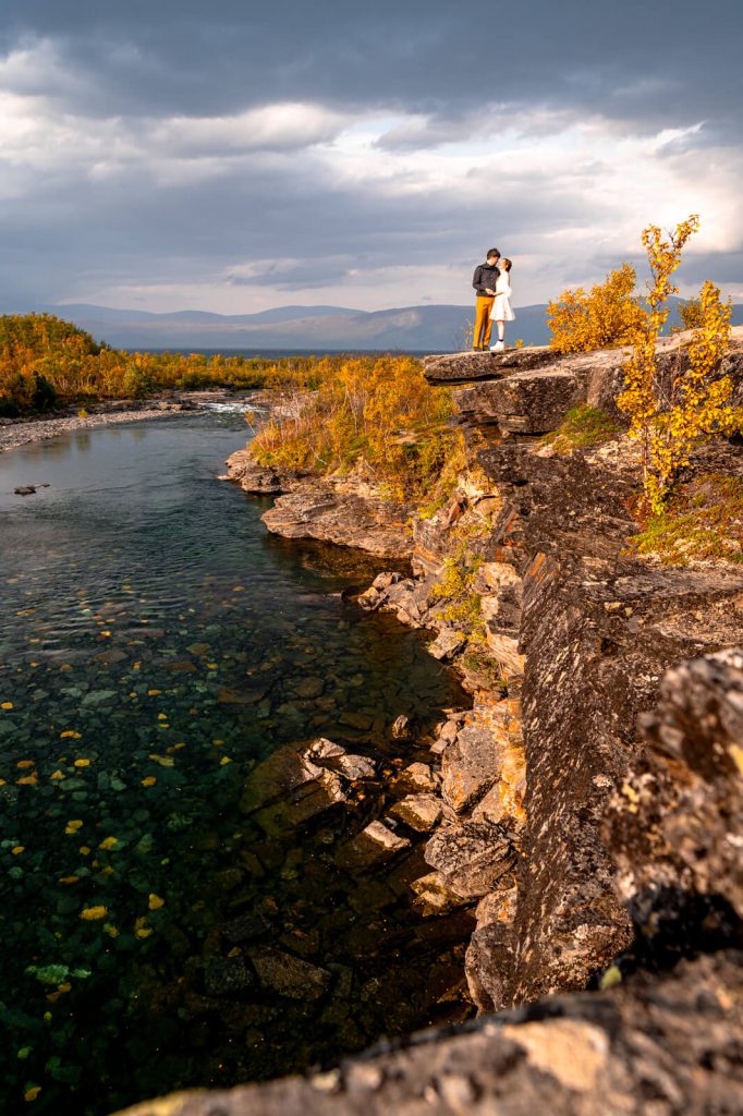 Couple eloping in Abisko national park on a high mountain cliff